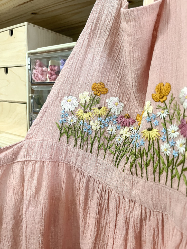 pink apron with wildflower embroidery